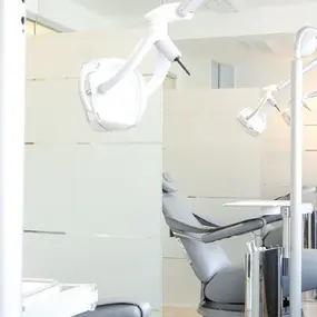 Moderne Zahnarztpraxis mit hellen Behandlungsräumen und ergonomischen Zahnarztstühlen.
